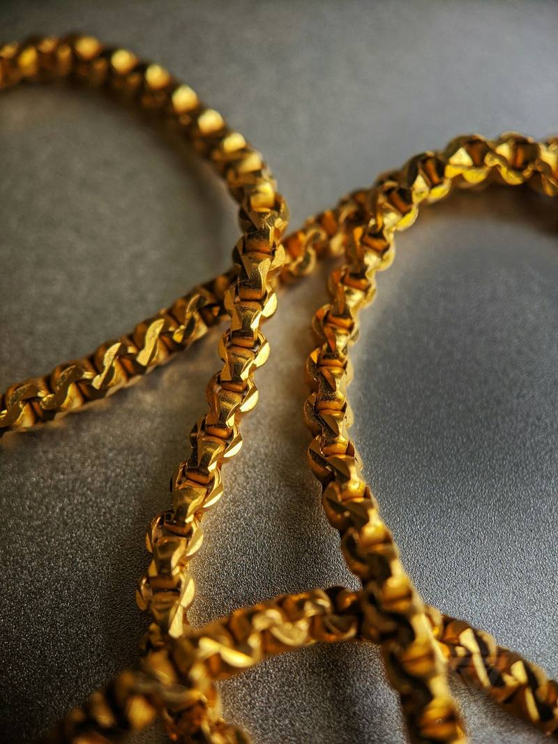 Worn chain links on a grey cloth (reference photo)